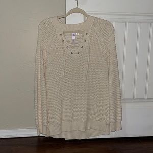 Cream colored sweater with crisscross strings in front